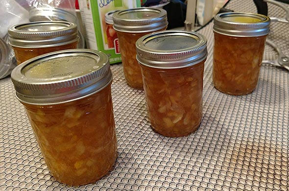 Jars of canned peach jam.