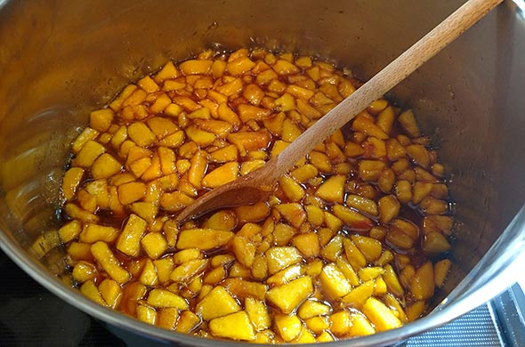 Makeing peach jam in a pot.