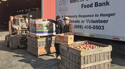 Men loading donated food onto a truck.